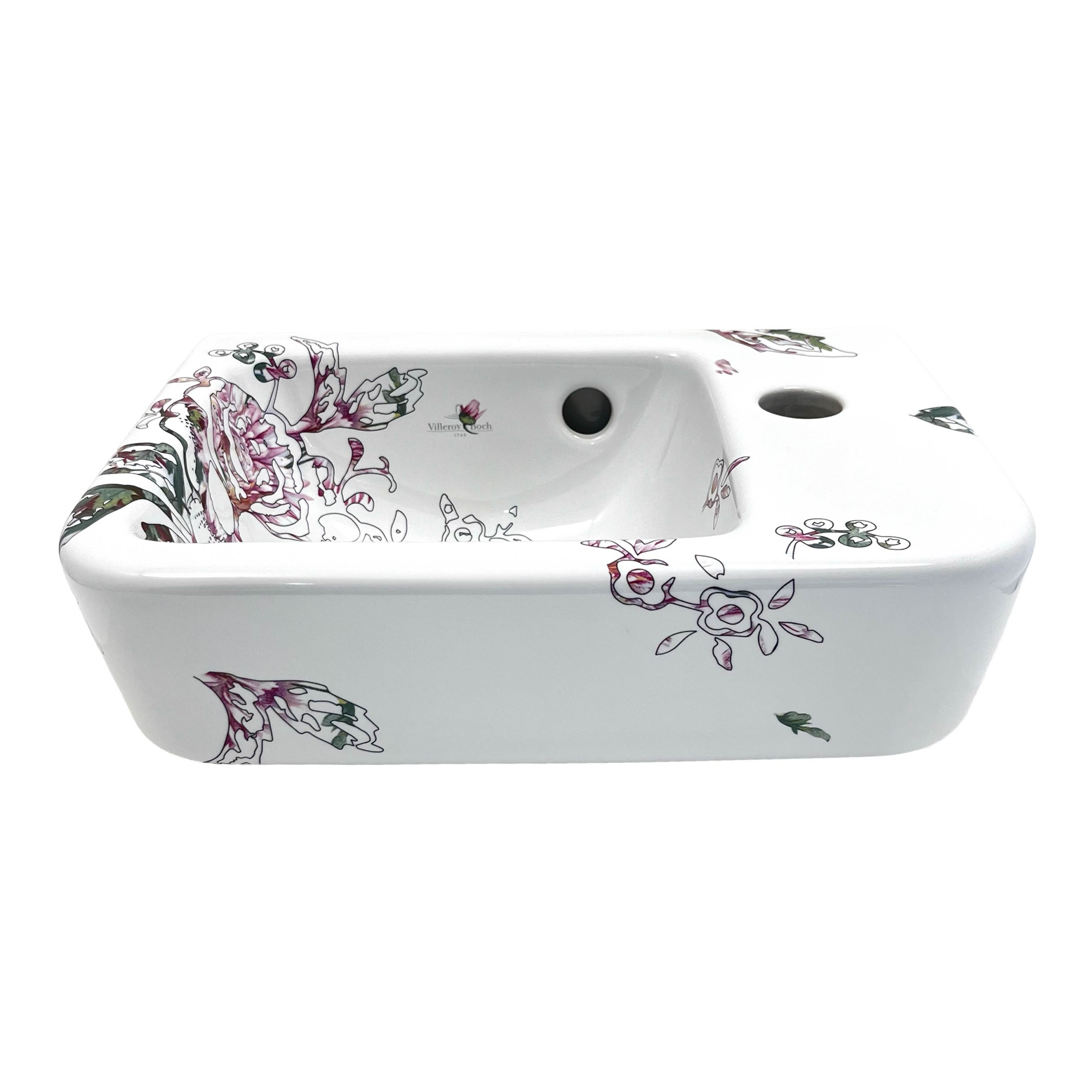 Toiletfontein met een illustratie van een roos bestaande uit fijne, zwarte lijnen, en een roze met lichtgroene invulling. Fragmenten uit de illustratie spatten over de randen heen
